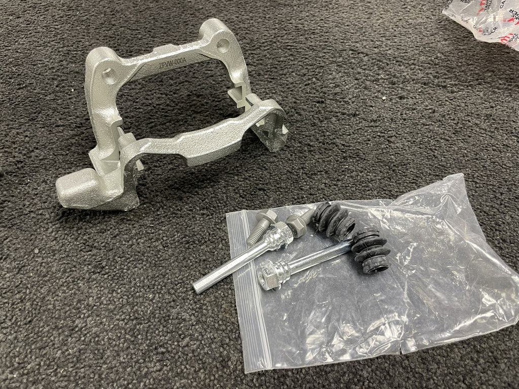 1x NEW REAR CALIPER BRACKET LH NS A3 GOLF MK5 MK6 TOURAN CADDY SUPERB LEON ALTEA
